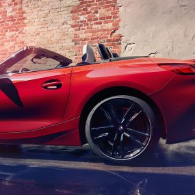 BMW Z4 Roadster 的側面拍攝 磚墻前的 BMW Z4 Roadster 的側面拍攝