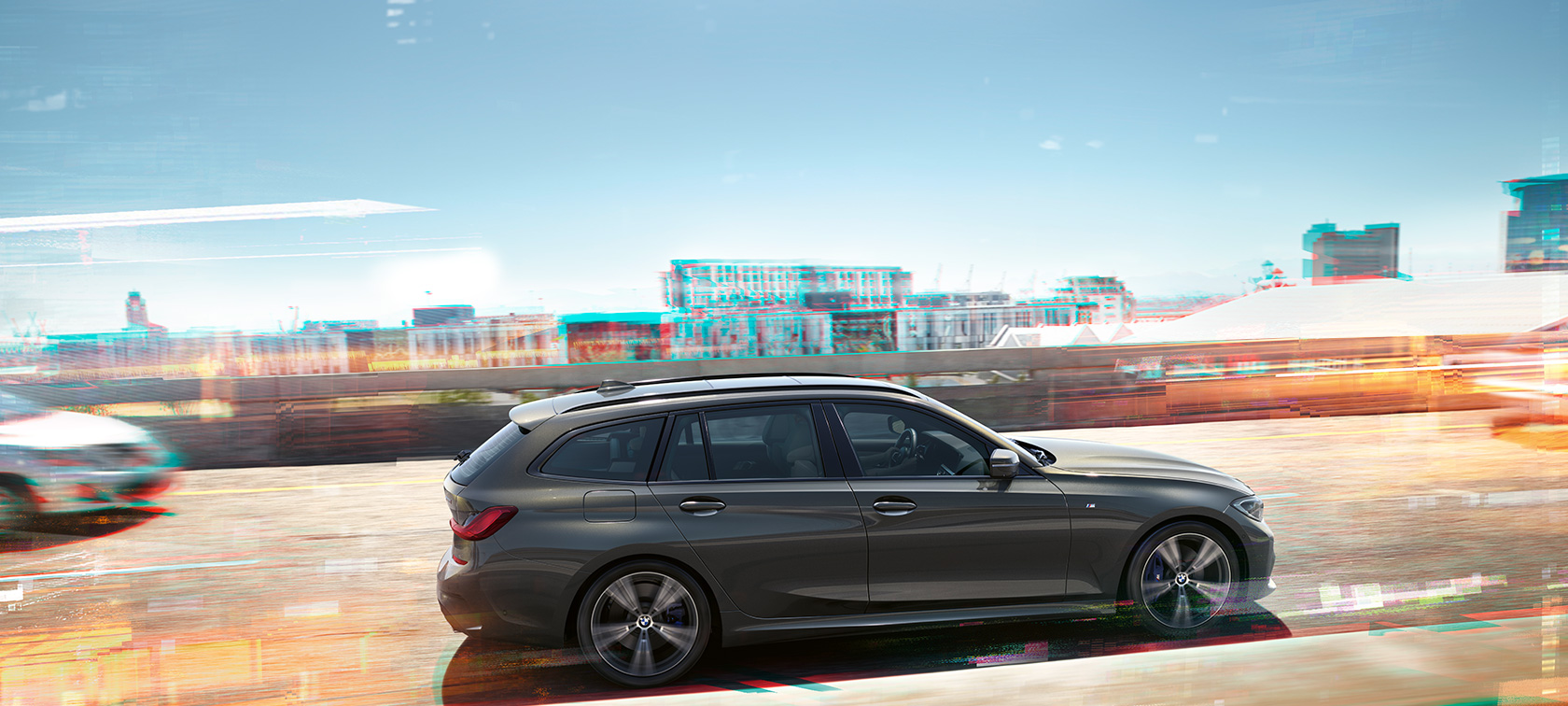 BMW 3 Series Touring, lateral driving shot BMW 3 Series Touring, lateral driving shot in front of houses