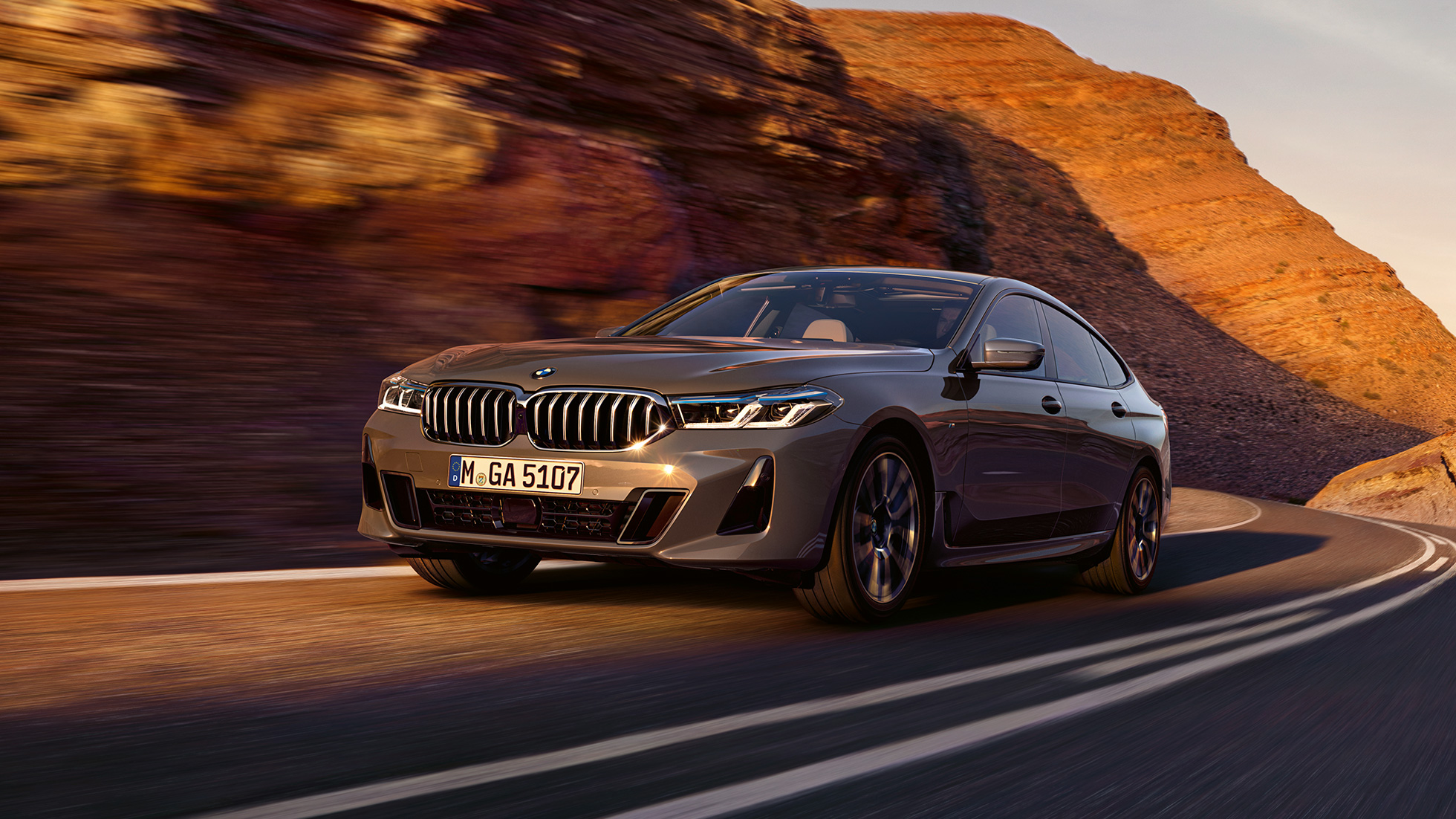 BMW 6 Series Gran Turismo G32 2020 BMW 6 Series Gran Turismo 640i xDrive G32 2020 Bernina Grey in three-quarter front driving in front of landscape