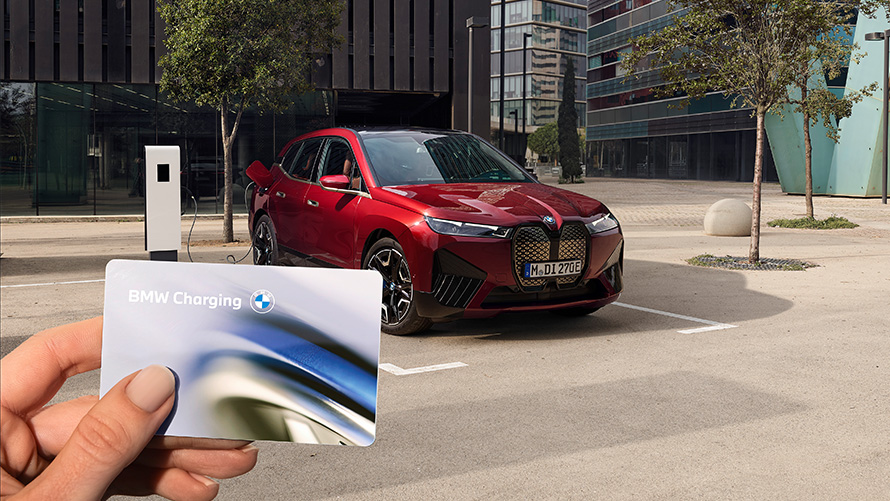 BMW iX i20 SUV electric car BMW iX xDrive50 charging BMW iX i20 2021 SUV electric car BMW iX xDrive50 Aventurin Red charging at a public high power charging station