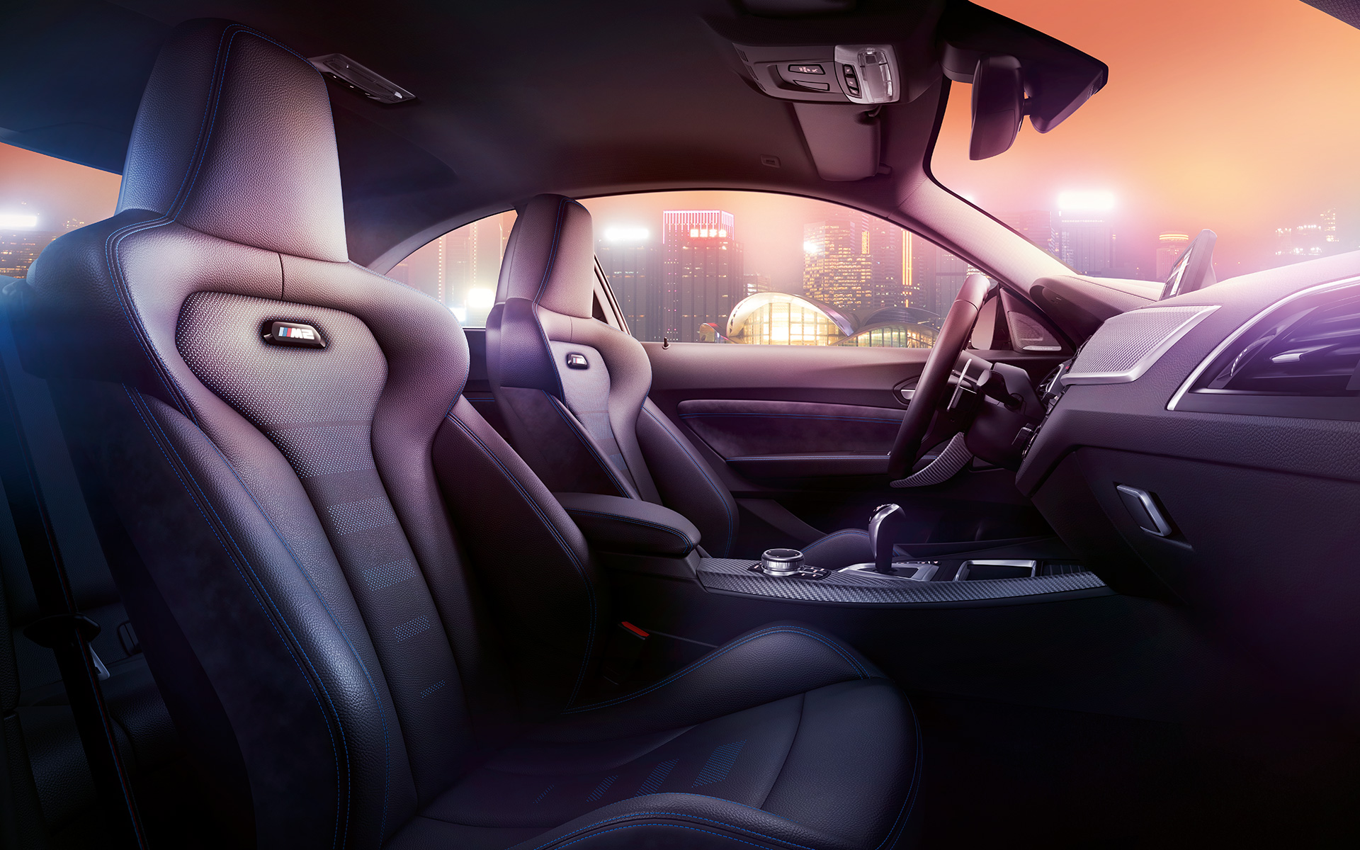 BMW M2 Competition Sport seats Cockpit and M Sport seats of the BMW M2 Competition, nocturnal skyline in the background