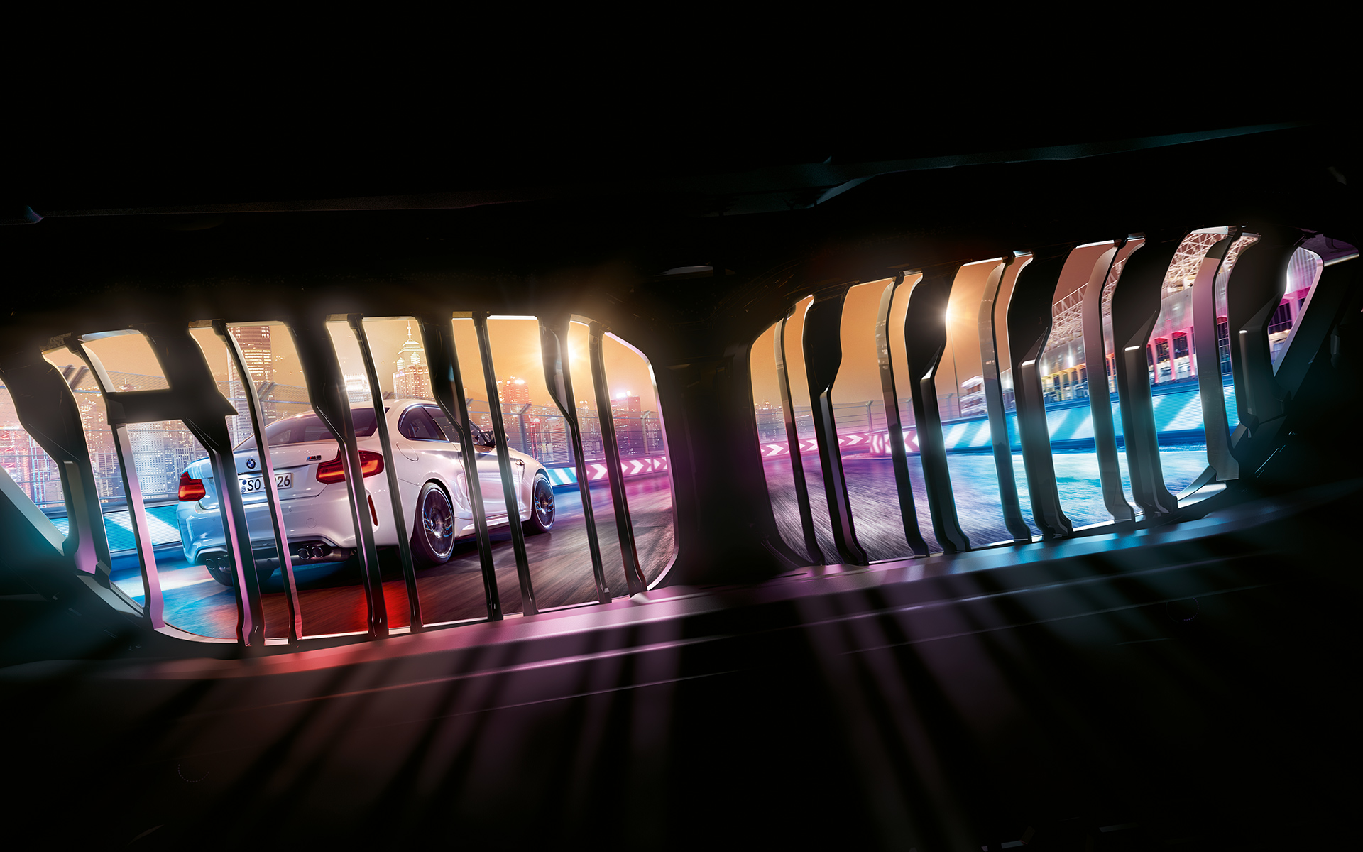 BMW M2 Competition kidney View through BMW kidney on preceding BMW M2 Competition on nocturnal race track.