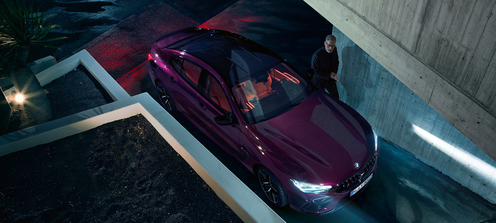 BMW M8 Competition Gran Coupé birds-eye view BMW M8 Competition Gran Coupé F93 2020 BMW Individual Ametrine metallic three-quarter standing in front of a building birds-eye view