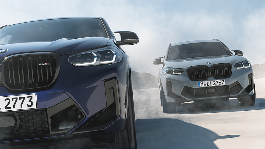 BMW X4 M F98 BMW Individual Velvetblue 與 BMW X3 M F97  BMW Individual Nardogrey 正在駕駛的前視圖 