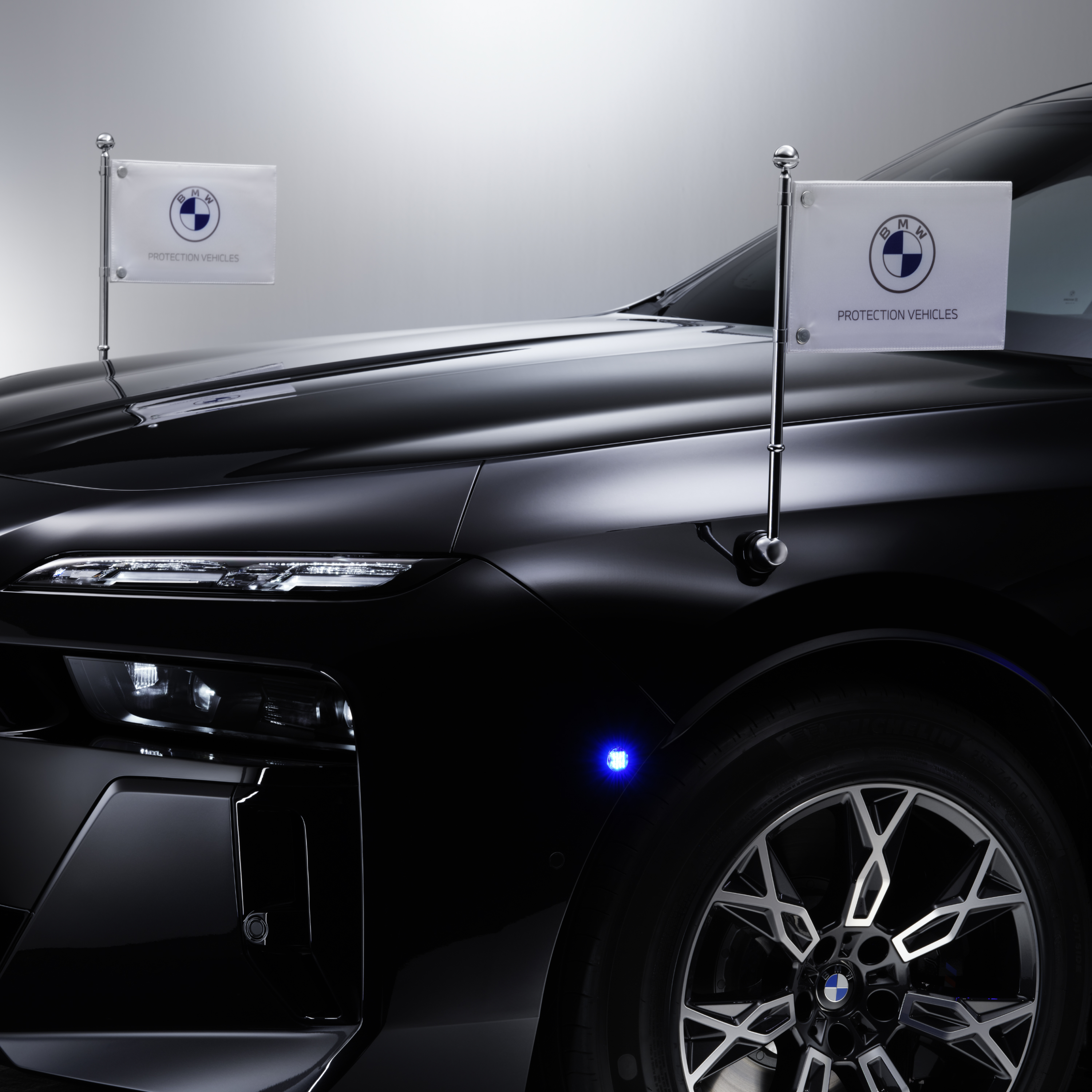 一輛前方有兩個旗幟的 BMW 特寫鏡頭
